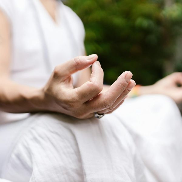 Close up of hands in a yoga mudra position.